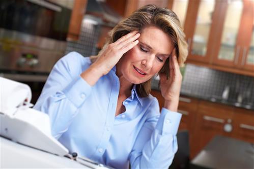 Woman having fighting migraine